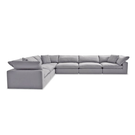 Arrange the large, light gray L-shaped sectional sofa with plush cushions in a modern, minimalist style. Featuring deep seating, wide arms, and a low profile, its perfect for spacious living rooms. Try out Free Fabric Swatches to ensure it complements your décor seamlessly.