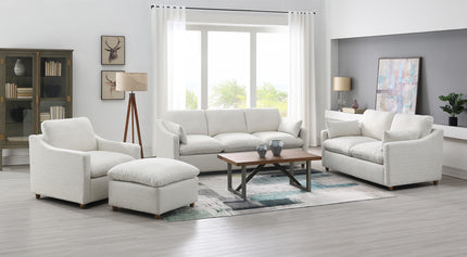 A modern living room features a My Cloud Slope Dover Linen Spill Proof 4 Piece Set with customizable furniture, including a sofa, matching armchairs, and an ottoman. A spill-proof wooden coffee table rests on a patterned rug near the floor lamp, large window, and art-adorned cabinet.