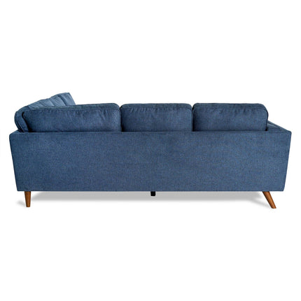 The living room features the Maddox sectional, a mid-century modern piece with three back cushions and angled wooden legs, all in blue and set against a white backdrop.