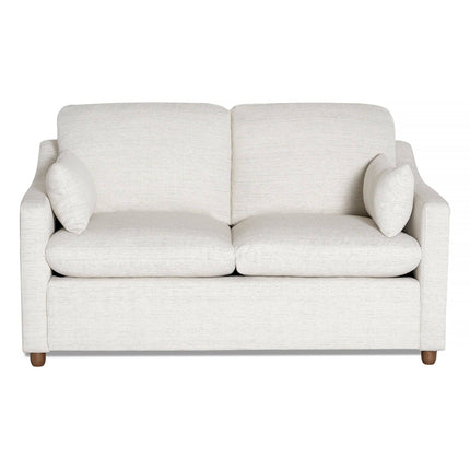 The cream-colored My Cloud Slope Loveseat features simple, clean lines with cushioned seats, two back cushions, and matching throw pillows. Its supported by four round wooden legs and exemplifies durable style and comfort.