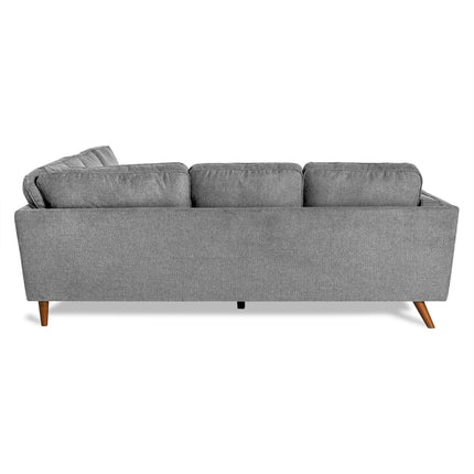 The Maddox Sectional, a modern gray fabric sofa with a mid-century vibe, features three cushions and rests elegantly on four wooden legs, making it perfect for any living room.