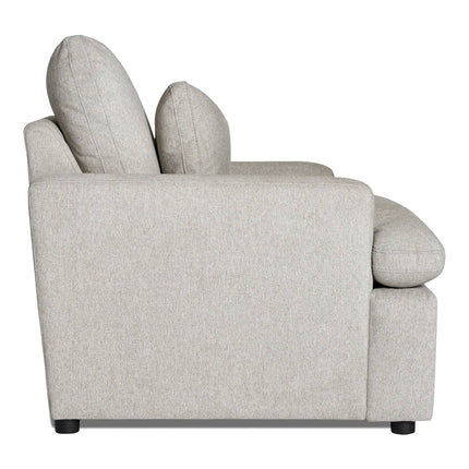 Side view of the light gray upholstered My Cloud Chair with thick cushions and black legs. Its wide, slightly curved armrest enhances comfort and style, making it a customizable fit for any living area.