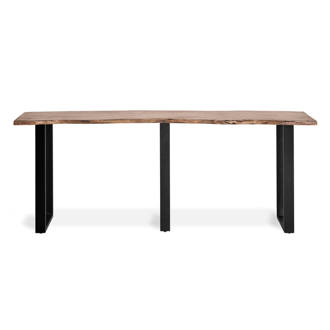 The Live Edge Console features a long wooden tabletop made of acacia wood, highlighting a textured grain for rustic charm. It is supported by three black, rectangular metal legs, providing a minimalist and industrial look that complements unique styles.
