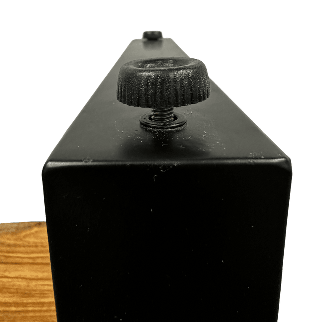 Close-up of a black metal box featuring a textured knob and visible screw, with a small black button in the background. At the bottom, part of the Live Edge End Tables natural wood surface adds rustic charm.