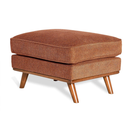 The Maddox Ottoman, with its mid-century modern design, features a rectangular shape, brown cushioned seat, and four angled wooden legs. Its textured fabric upholstery adds warmth and coziness, making it perfect for any living space.