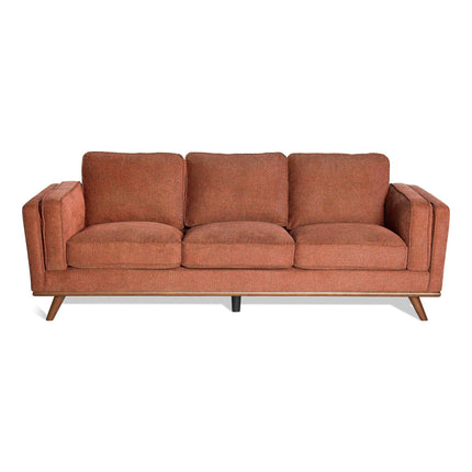 The Maddox Sofa Set features mid-century modern design with plush, loose cushions in warm terracotta. It includes angled wooden legs and sturdy armrests, perfect for a sleek, minimalist look in any contemporary space.