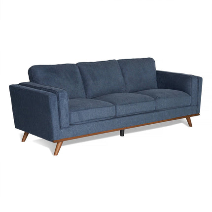 Introducing the Maddox Sofa, a modern blue fabric piece with plush cushions and angled wooden legs. This mid-century design features clean lines, padded armrests, and a wooden base for added warmth to its inviting look.