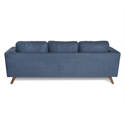 Back view of the Maddox Sofa, a modern three-seater with blue fabric upholstery and wooden legs. Its rectangular shape, plush cushions, and clean lines bring mid-century modern charm to any contemporary space.