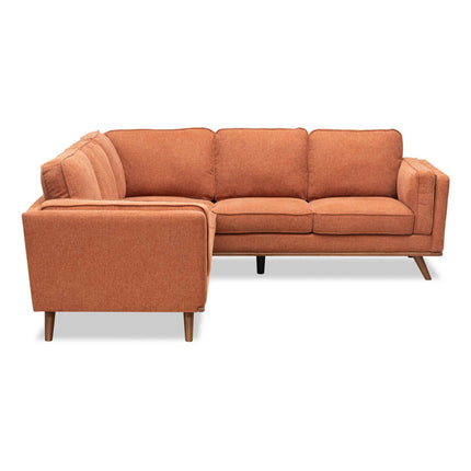 The Free Fabric Swatches offer a mid-century modern L-shaped sectional in burnt orange with tufted cushions and angled legs, ideal for a minimalist, contemporary living room.