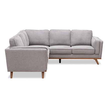 The Free Fabric Swatches modern sectional sofa has an L-shape and wooden legs, featuring cushioned seats and backrests. Its gray with soft fabric, showcasing a minimalist and stylish design ideal for a contemporary living room.