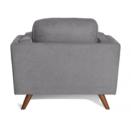 Back view of the Maddox Chair, a gray fabric-upholstered, mid-century modern armchair featuring wooden legs and plush cushions, shown against a white background.